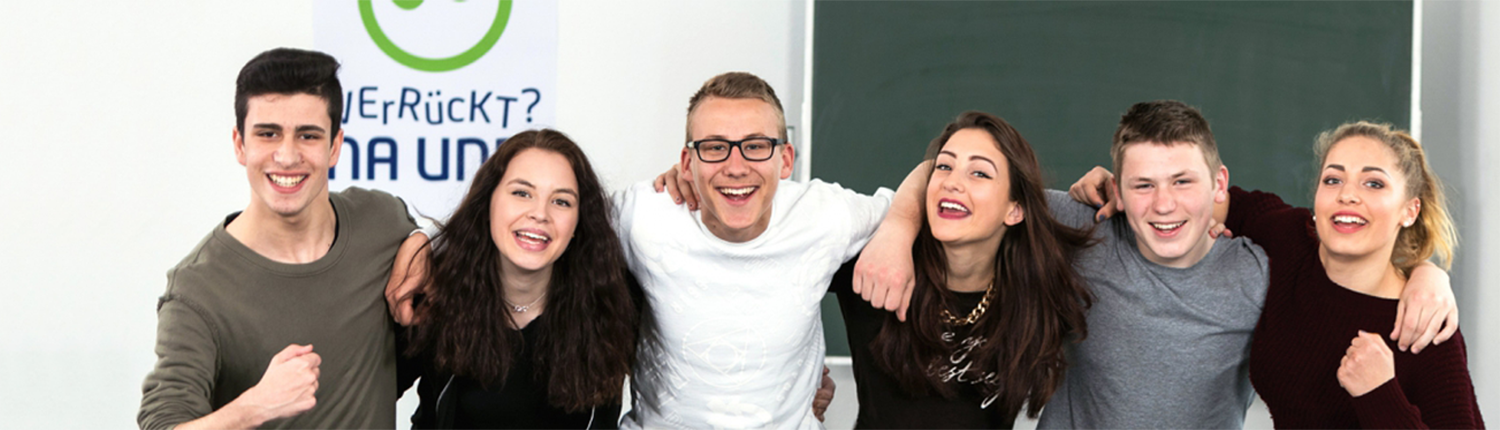 Eine Gruppe junger Menschen lacht in die Kamera